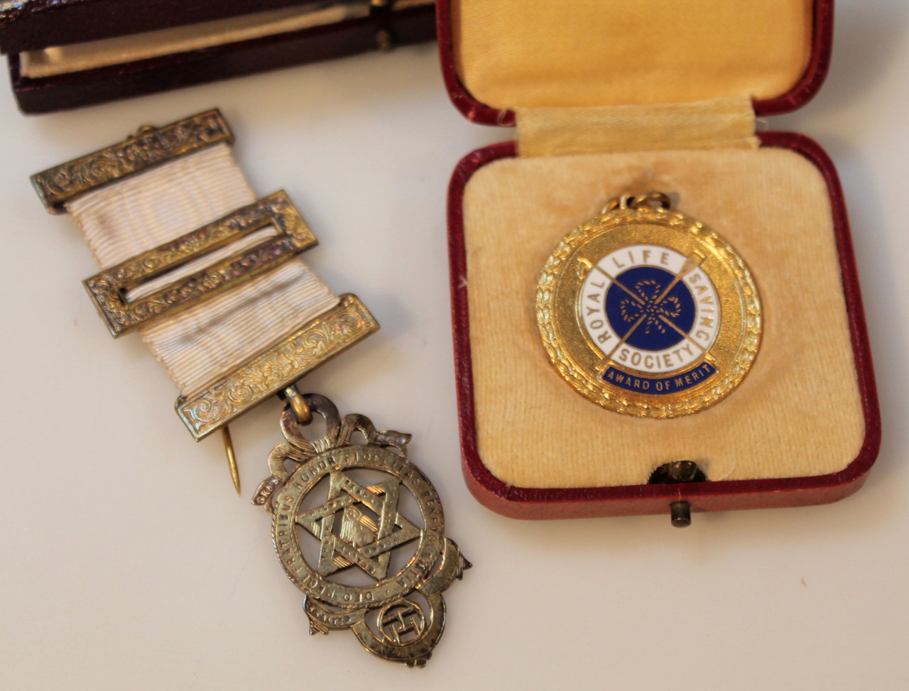 A Masonic style gilt metal medal, with cloth ribbon and metal mounts, 10cm high and a Royal Life