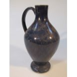 A tin glazed earthenware flagon, of bellied form with plain handle, the blue body picked out with