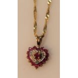 A heart shaped pendant, claw set with small pink and white stones attached to a slender link