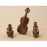 An early 20thC novelty brass vesta case, in the form of a cello, articulated match strike base and