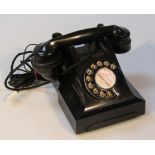 A 20thC black Bakelite telephone, the receiver attached by cord, No.184S43/1, with front drawer, and