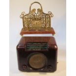 A mid 20thC Bush brown Bakelite radio, with material speaker, panel front and a glass dial, 26cm