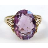 A ladies 9ct gold and amethyst ring, with an oval claw set stone, on a part pierced shank, size T,