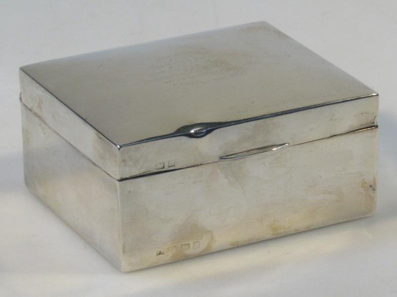 A George V silver cigarette case, by Thomas Bishton, with thumb mould handle and cedar lined