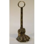 A mid-19thC brass lions paw door stop, with a compressed ring top above a acanthus leaf stem,