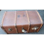 An early 20thC pressed leather travel trunk, with a wooden banding set with gilt coloured metal