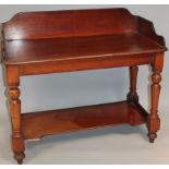 A Victorian mahogany wash stand, with a three part galleried back raised above turned supports,