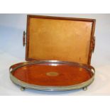 A mid-20thC oak tea tray, with a plated galleried edge, the oval body on orb supports, centred by