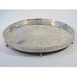 A 20thC silver plated galleried edge tea tray, with a circular outline the heavily pierced garland