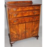 A mid-20thC walnut veneered compactum chest, the quarter veneered top raised above three long