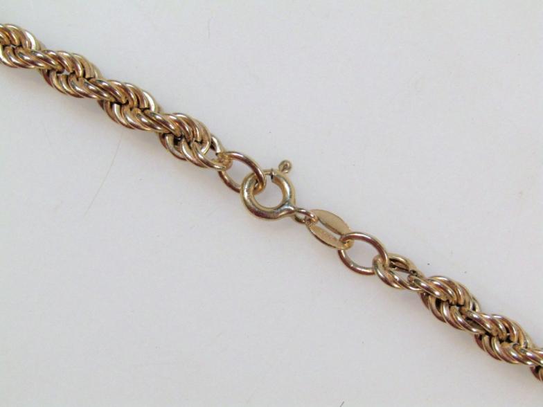 A rope twist necklace, hollow with plain clasp, yellow metal marked 375, 66cm long. - Image 2 of 2