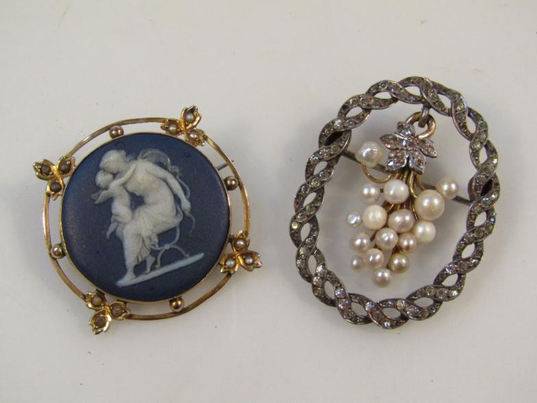 An oval drop brooch, set with an arrangement of pearls on a yellow metal ground with a white metal