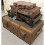 An early 20thC wooden bound and leather travelling trunk, with leather side handles and a part