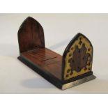 A late 19thC walnut and ebonised extending book slide, with castellated part gilt metal ends on a