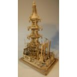 A Qing period Chinese ivory freestanding model of a pagoda, the fenced front before a staircase