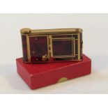 A mid-20thC Swiss vanity case, in the form of a camera, with gilt trim set with removable lipstick