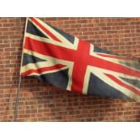 An early 20thC Union Jack flag, on an ebonised flag pole, 299cm high. (AF)