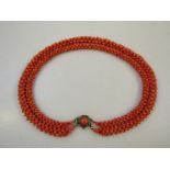 An early 20thC coral necklace, heavily set with five various strands, the clasp set with a coral