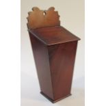 A 19thC mahogany wall hanging candle box, with a shaped back plate raised above a slope lid