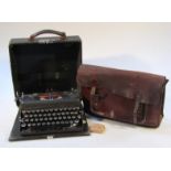 A mid-20thC Imperial typewriter, in a pressed black, leather and card case, with articulated and