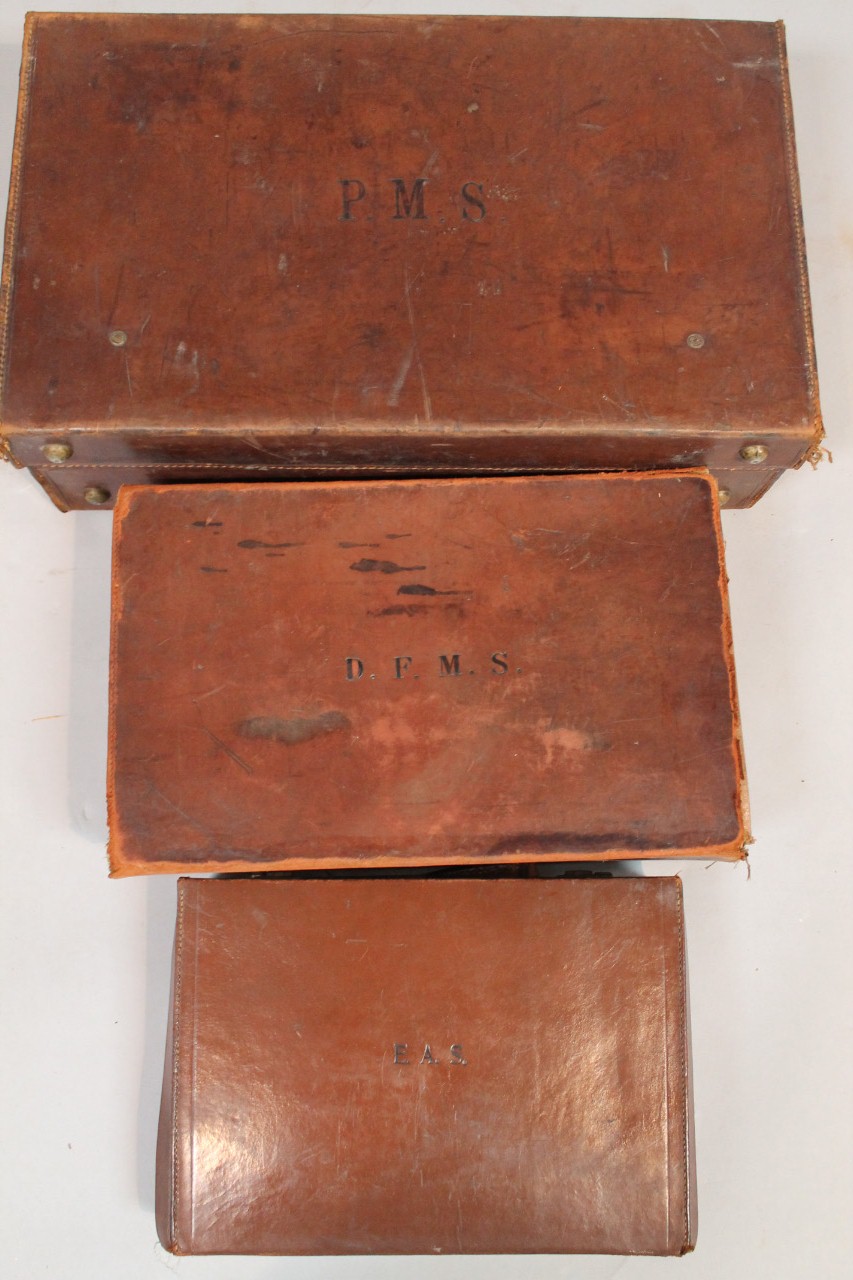 An early 20thC pressed brown leather travelling case, with exterior articulated metal locks and - Image 2 of 2