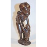 A 20thC African tribal figure group, of a figure and child, each standing on a shaped base, 31cm