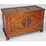 A 20thC oak Jacobean style three panelled coffer, the plain lid hinging to reveal a plain interior