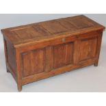An oak three panelled coffer, the overhanging plain top hinging to reveal a plain interior with