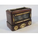 A 19thC rosewood three bottle travelling case, the exterior with bone inlay in a two sided glass