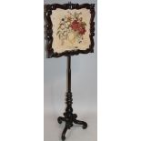 A 19thC mahogany pole screen, the cylindrical tapering stem fronted by a shaped square panel with