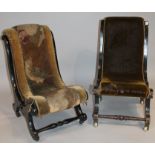 A near matching pair of open low nursing chairs, each with ebonised scroll outlines overstuffed in