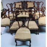 A late Victorian mahogany framed part salon suite, comprising two carver chairs each with carved
