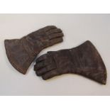 A pair of early 20thC leather driving gauntlets, with Newey patent chrome studs, in brown