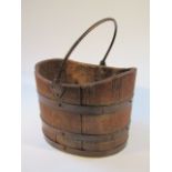 An oak and metal bound coopered bucket, with metal swing handle and interior label R. Allister & Co.