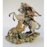 A 20thC Capo-di-Monte Marinni figure, of the Tiger Hunt, formed as a gentleman on horseback fighting