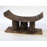 A 19thC hardwood headrest, the shaped top held on part carved supports centred by a pierced barrel