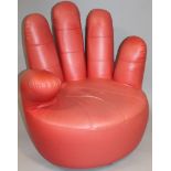 A mid-20thC Joe Colombo style red leather hand chair, with a finger back and thumb arm on a circular