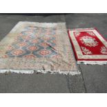 A hand stitched rug, in geometric pattern in grey and red with a floral centre, 230cm wide, and a