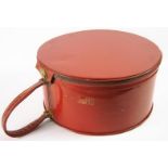 A 1970s red plastic hat case, with patent label It's a lark, (New York), with zip fastener and