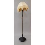 A 1960's floor lamp, with brass column and black finished metal base and lamp holder support, with