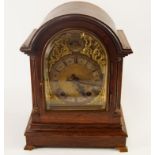 An early 20thC eight day mantel clock, in oak case, chiming on a gong, 30cm high.