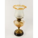 A Victorian brass oil lamp, with whorl fluted clear glass reservoir and frosted glass shade, 50cm to