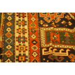 A Middle Eastern bordered rug, with stylized geometric designs in blue, green and red, 170cm x