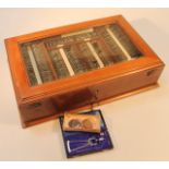 An early 20thC mahogany opticians tester lens set, the rectangular box with a bevelled glass door,