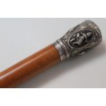 An early 20thC lightwood cane, the cylindrical stem headed by a knop raised with elephants and