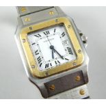 A Cartier wristwatch, with Santos movement, with stainless steel strap and yellow metal design,