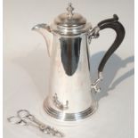 A 20thC silver plated coffee pot, in the George I style with a tapering cylindrical outline,