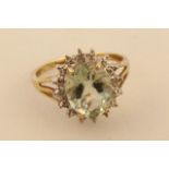 A ladies claw set dress ring, set with a green stone surrounded by small diamonds on a floral