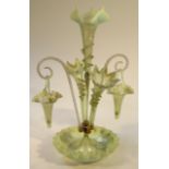 A Victorian vaseline and clear glass epergne, the central floral trumpet flanked by barley sugar and