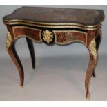 A 19thC French Boulle ebonised and ormolu games table, with serpentine outline the top fronted by